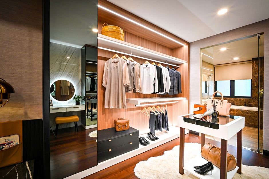 Luxurious custom walk-in closet with beautiful shelving and lighting